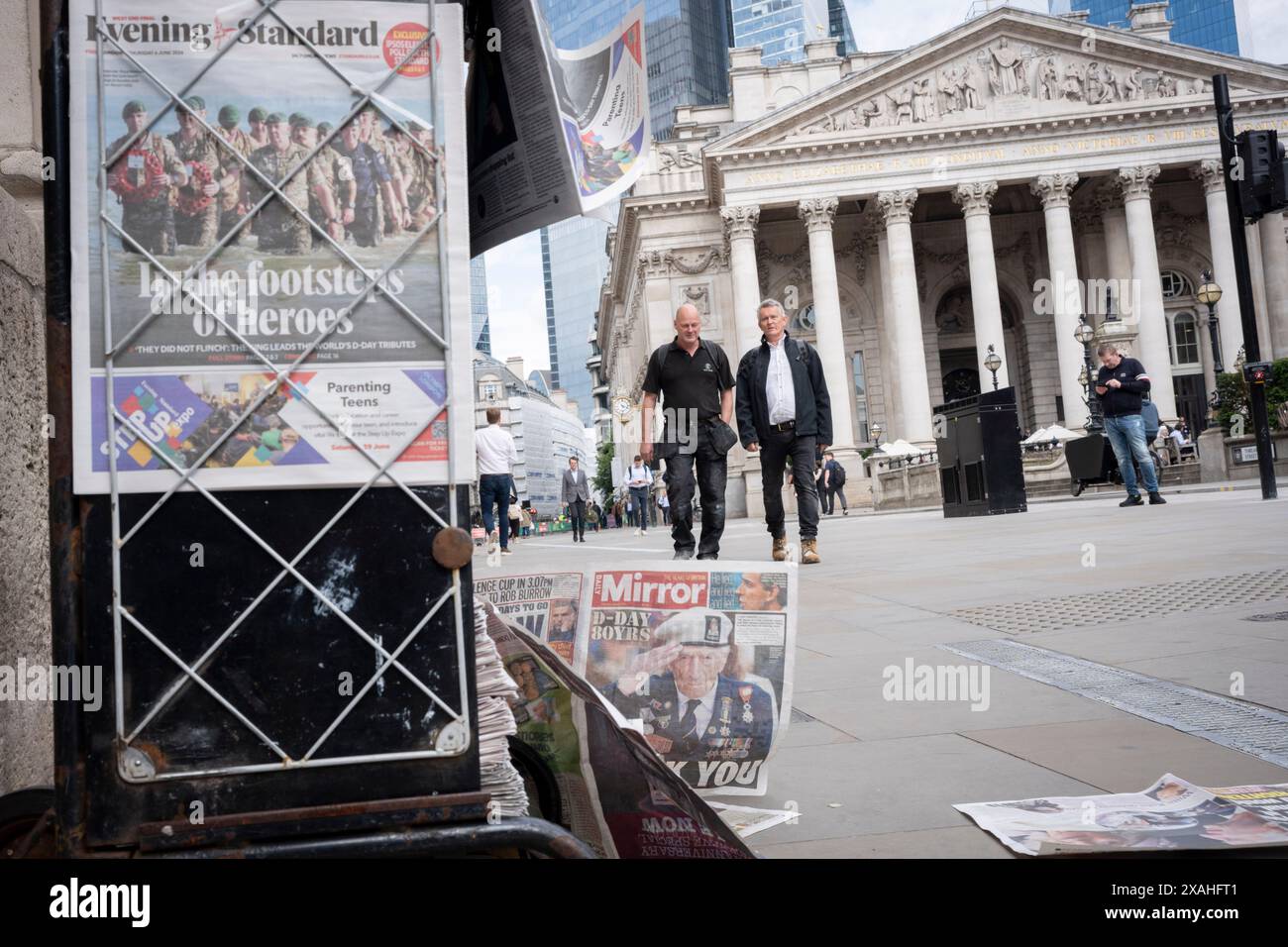 Mitglieder der Public Walk Past the Evening Standard News Schlagzeile, die über den 80. Jahrestag der Landung des D-Day in der City of London, dem Finanzviertel der Hauptstadt, am 6. Juni 2024 in London, England berichtet. Besitzer des Evening Standard haben angekündigt, dass der Titel der Daily London bald nach 97 Jahren nicht mehr täglich veröffentlicht wird. Stockfoto