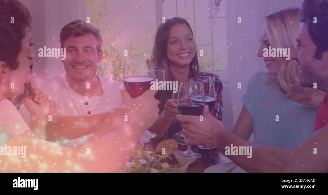 Bild von Lichtern über glücklichen kaukasischen männlichen und weiblichen Freunden, die mit Wein tosten Stockfoto