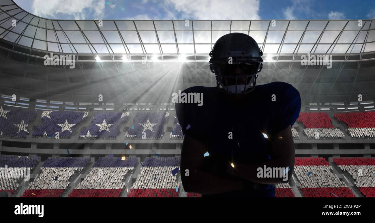 Konfetti fällt über männlichen american Football-Spieler, der einen Helm gegen das Sportstadion trägt Stockfoto