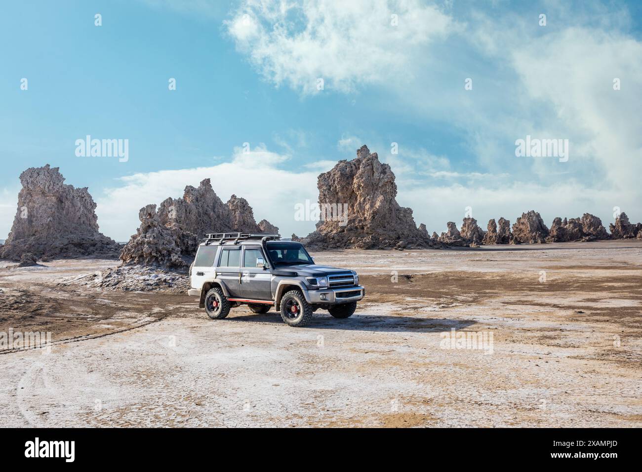 Prähistorische Kalksteinschornsteine am Boden des getrockneten Sees und Geländewagen, Salzsee Abbe, Dikhil Region, Dschibuti Stockfoto