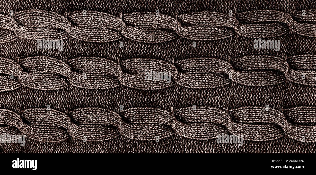 Nahaufnahme aus grauem Strickgewebe mit Drehungen Stockfoto