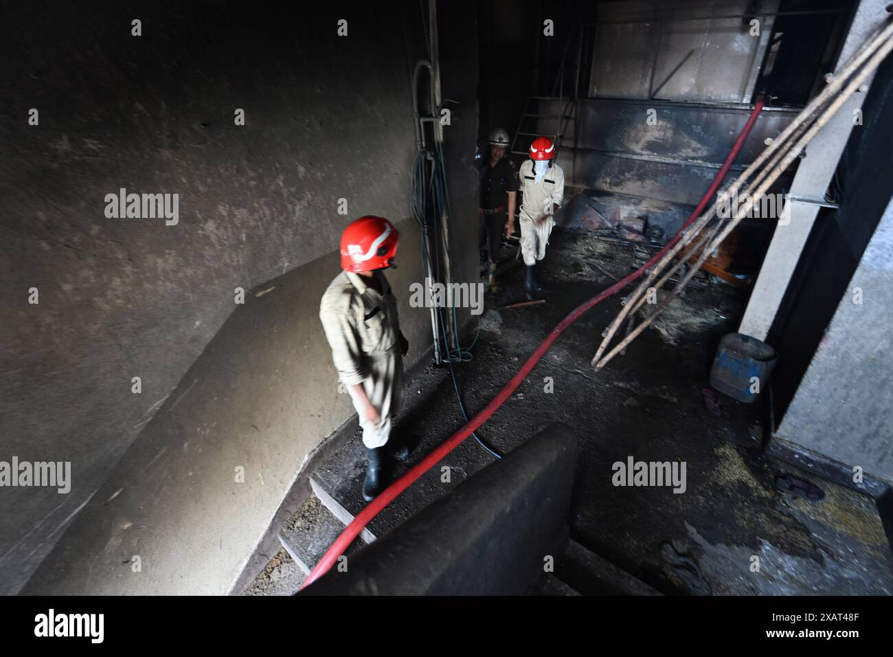 NEW DELHI, INDIEN - 8. JUNI: Eine Ansicht der Feuerwehrleute, die versuchen, das Feuer zu entwässern, das am frühen Morgen in der Fabrik für Spaltimpulse im Narela-Industriegebiet H-Block am 8. Juni 2024 in Neu-Delhi, Indien ausbrach. Mindestens drei Arbeiter wurden getötet, während sechs weitere schwer verletzt wurden, nachdem ein massiver Brand ausbrach, der eine Explosion in einer Lebensmittelverarbeitungseinheit in Delhis Narela verursachte, sagten Beamte. Vorläufige Untersuchungen zeigen, dass das Feuer aufgrund eines Gaslecks in einer der Leitungen ausgebrochen ist, sagte die Polizei. Bei einer Brandausbreitung kam es zu einer Überhitzung des Kompressors und einer Explosion. (Foto: Raj K Raj/Hind Stockfoto