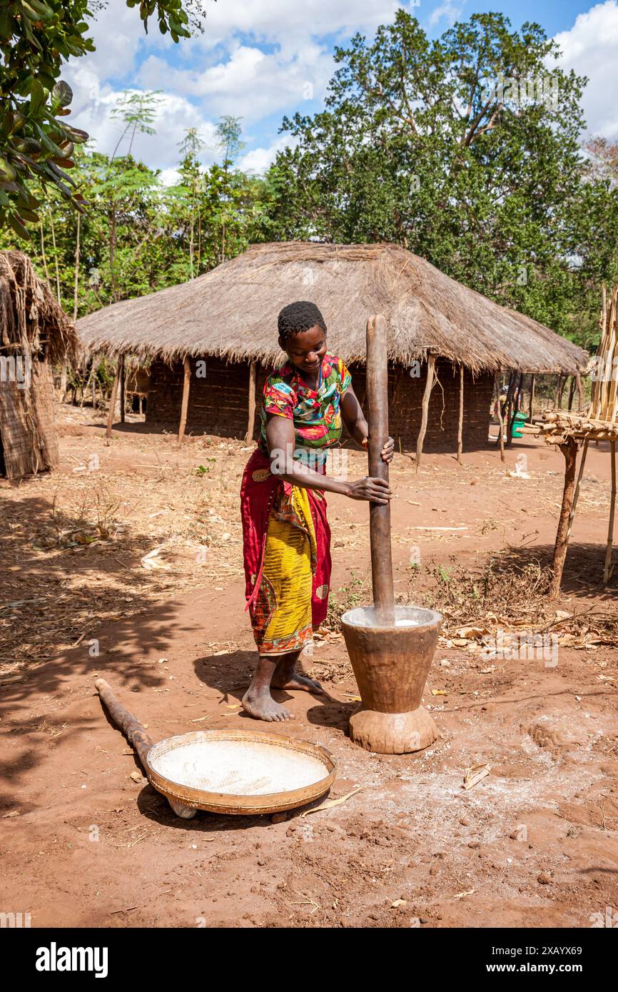 Mosambik, Cabo Delgado, unterwegs, Frau mahlt Müsli Stockfoto