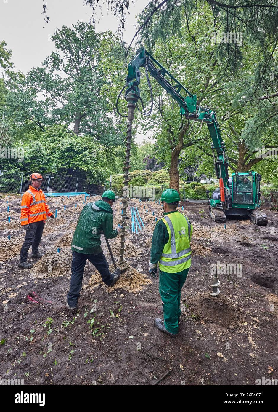 Hamburg, Deutschland. Juni 2024. Stefan Pfeifer (l), Feuerwehrmann aus der Entsorgungseinheit Sprengstoffverordnung, steht mit seinen Bohrassistenten bei der Erkundungsbohrung auf einer Baustelle in Planten un Blomen. Eine neue Luftbildanalyse hat einen Bereich auf dem Grundstück als verdächtiges Gebiet eingestuft. Die Sondierungsarbeiten werden voraussichtlich vier Tage dauern. Quelle: Georg Wendt/dpa/Alamy Live News Stockfoto