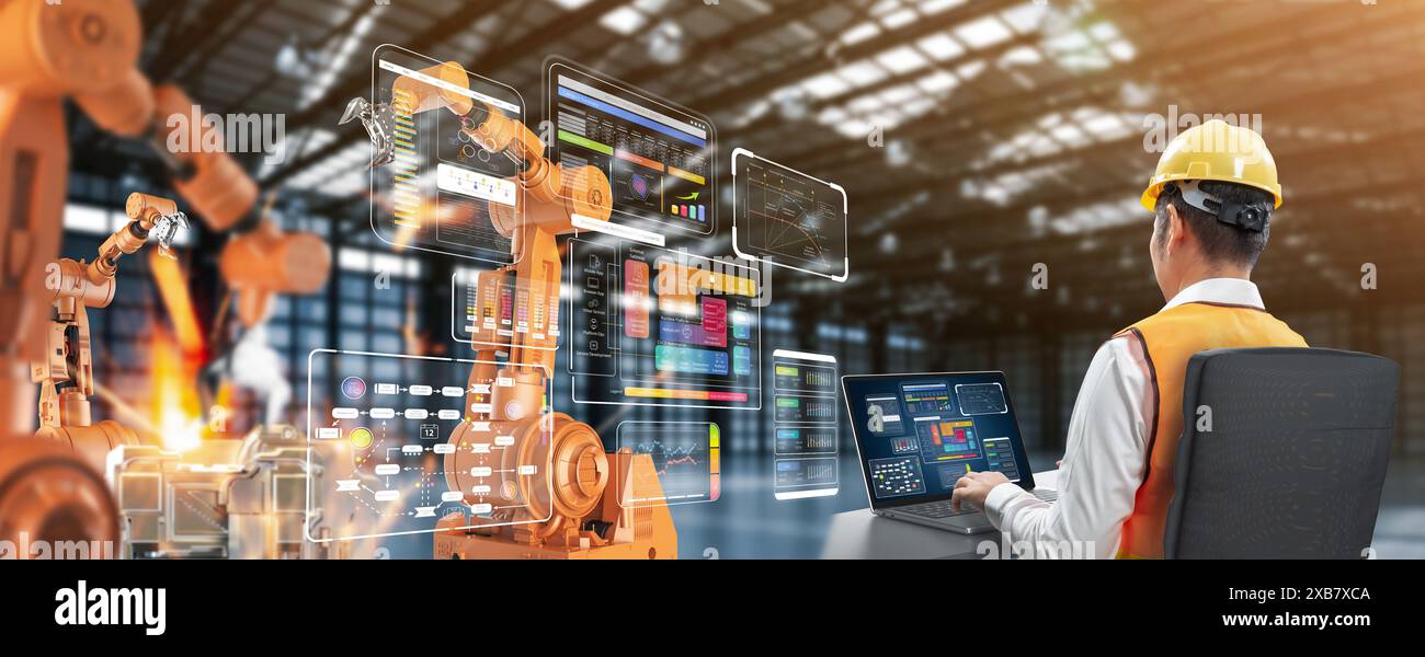 Techniker oder Ingenieure arbeiten mit Roboterarmen im Werk Stockfoto