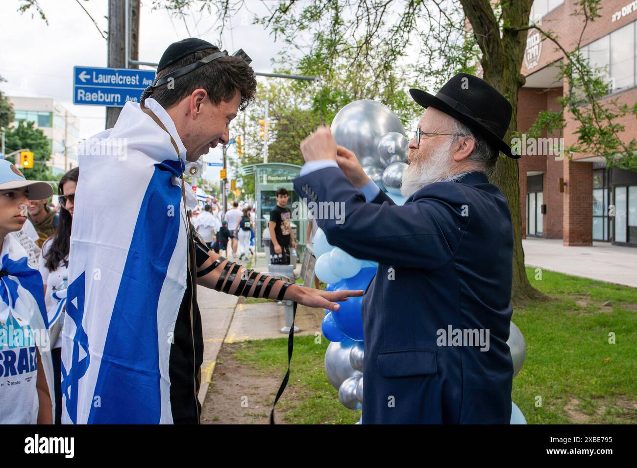 9. Juni 2024, Toronto, Ontario, Kanada: Die Teilnehmer erhalten Tefillin während des UJA (United Jewish Appeal Federation of Greater Toronto) Annual Walk for Israel march. Der UJA Walk for Israel in Toronto am 9. Juni zog über 40.000 Teilnehmer an und zeigte die starke Unterstützung und Solidarität der Gemeinschaft mit dem Staat Israel, insbesondere angesichts der tragischen Ereignisse vom 7. Oktober. Diese jährliche Veranstaltung bot eine Reihe von Aktivitäten, von kulturellen Aufführungen bis hin zu familienfreundlicher Unterhaltung, die eine lebendige und inklusive Atmosphäre förderten. (Credit Image: © Shawn Goldberg/SOPA Images via ZUMA Stockfoto