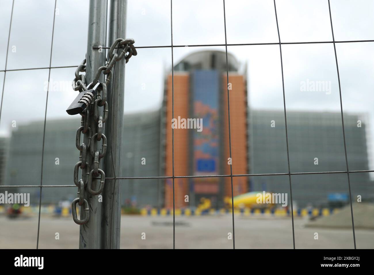 (240612) -- BRÜSSEL, 12. Juni 2024 (Xinhua) -- dieses Aktenfoto vom 3. Juni 2024 zeigt ein Schloss an Ketten im Hintergrund des Gebäudes der Europäischen Kommission in Brüssel, Belgien. Die Europäische Kommission gab am Mittwoch eine Erklärung ab, in der sie die Höhe der vorläufigen protektionistischen Zölle auf Einfuhren von batteriebetriebenen Elektrofahrzeugen aus China vorab offenlegt. Die Europäische Kommission wies Anträge und Bedenken zahlreicher Regierungen und Industriesektoren der EU-Mitgliedstaaten ab, wobei sie die Fakten übersah und gegen die Regeln der Welthandelsorganisation verstieß. Auf dem Weg zu ihrem Handelsprotektionist Stockfoto