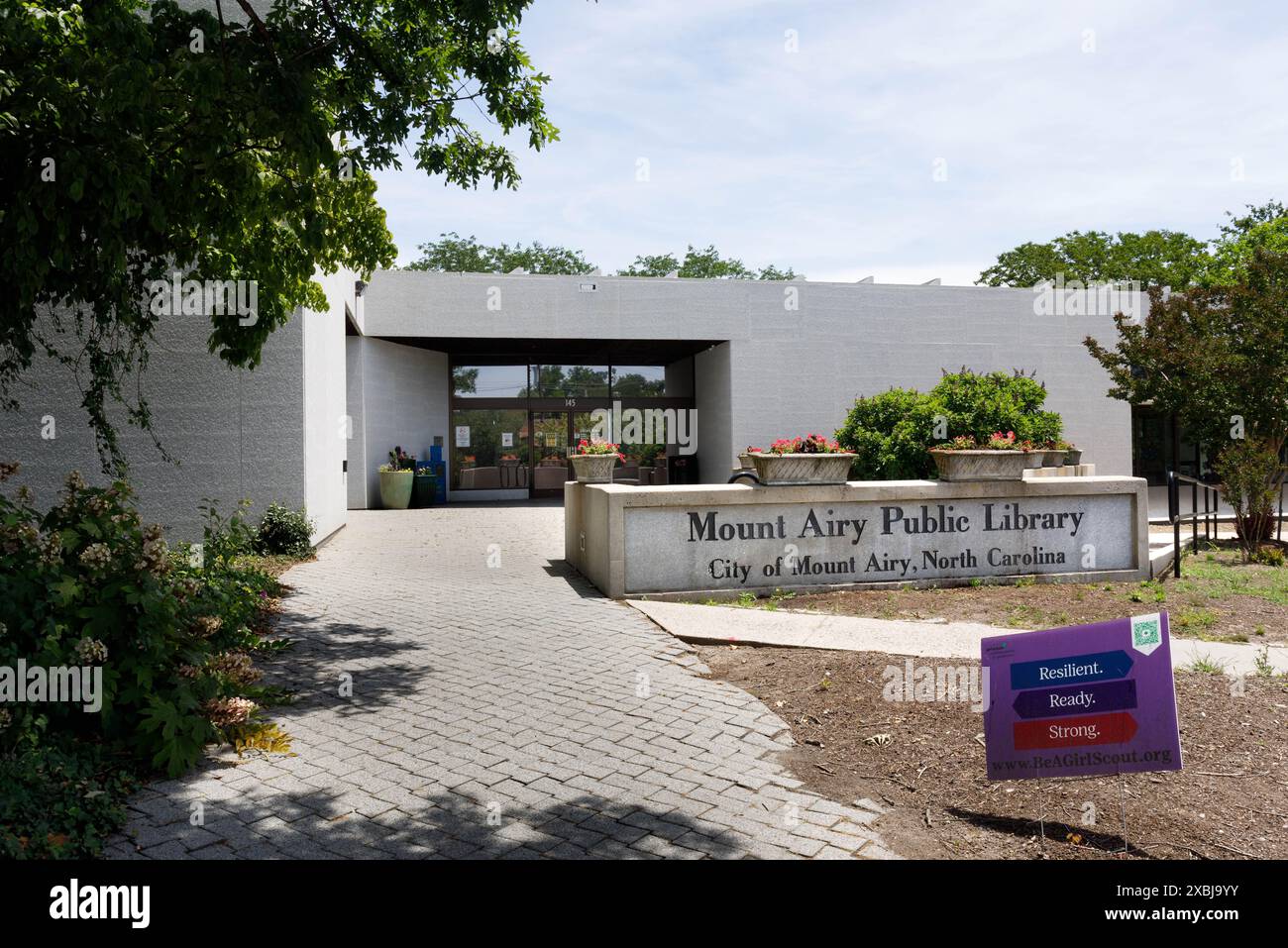 Mt. Airy, NC, USA-1. Juni 2024: Haupteingang zum Mt. Luftige öffentliche Bibliothek, mit gemauertem Gehweg und Denkmalschild. Stockfoto