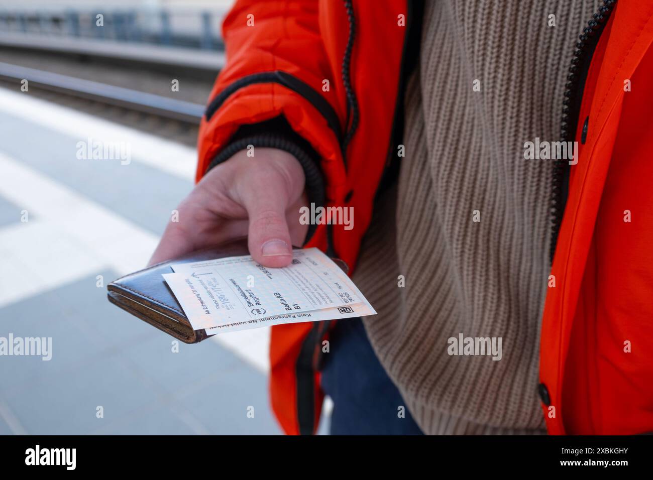 Männlicher Passagier mit Fahrkarte der Deutschen Bahn, öffentlicher Nahverkehr, Reiseffizienz, moderne Verkehrsmittel, Berlin, Deutschland - 24. April 2024 Stockfoto