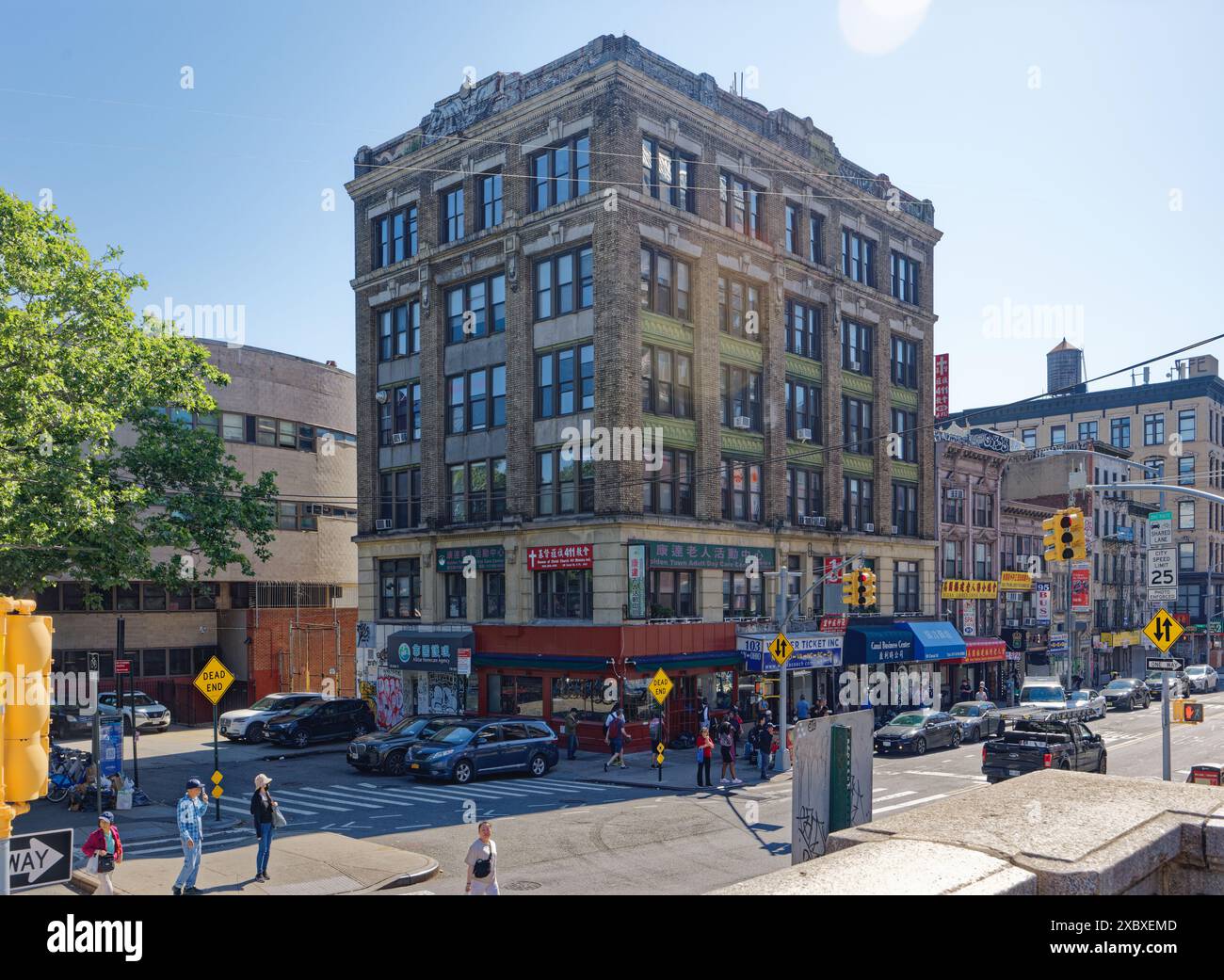 NYC Chinatown: 99 Canal Street ist ein Wohn-/Geschäftsgebäude aus braunem Backstein und Stein mit grünen Metallspandrel-Akzenten. Stockfoto