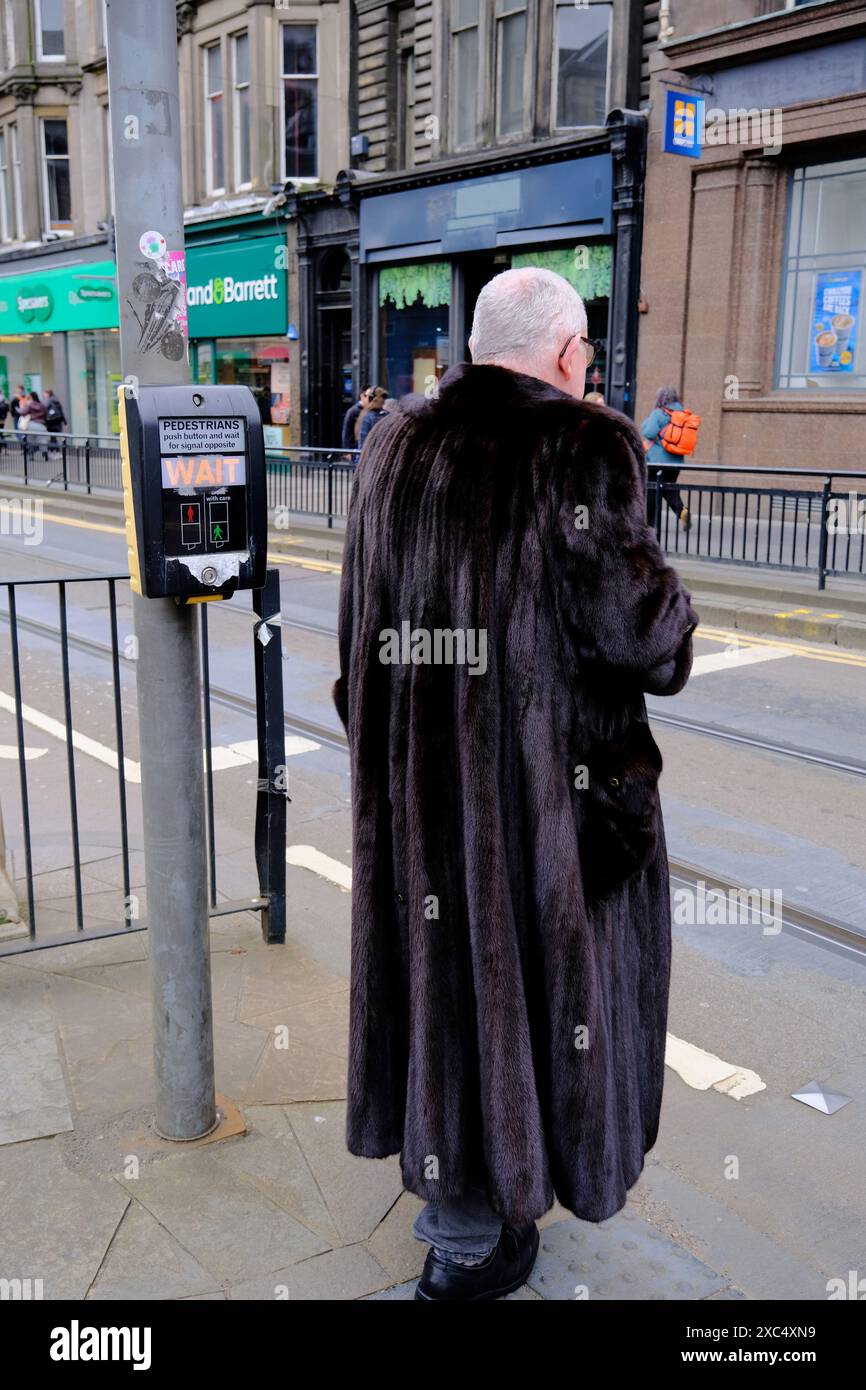 Ein Mann mit Pelzmantel auf der Straße von West End, Edinburgh, Schottland, Großbritannien Stockfoto Ein Mann mit Pelzmantel auf der Straße von West End, Edinburgh, Schottland, Großbritannien Stockfoto
