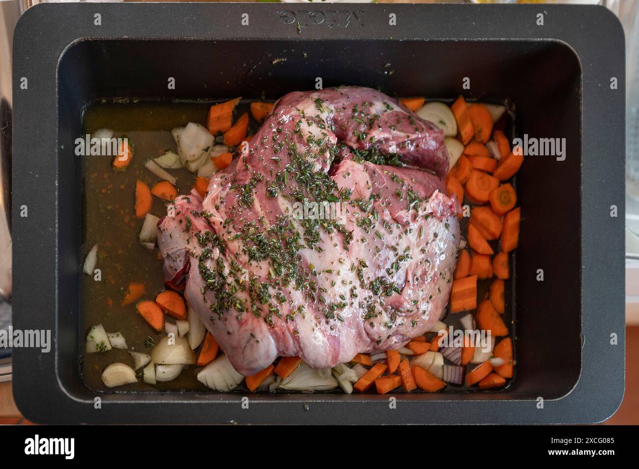 Lammbraten mit Kräutern und Gemüse in einem Auflauf vor dem Rösten, Bayern, Deutschland Stockfoto
