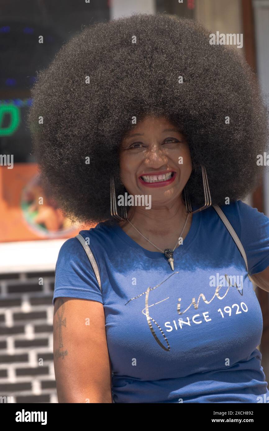 Eine attraktive Frau mittleren Alters mit einer tollen Afro-Frisur bei der jährlichen Juneteenth Parade in Peekskill, New York. Stockfoto