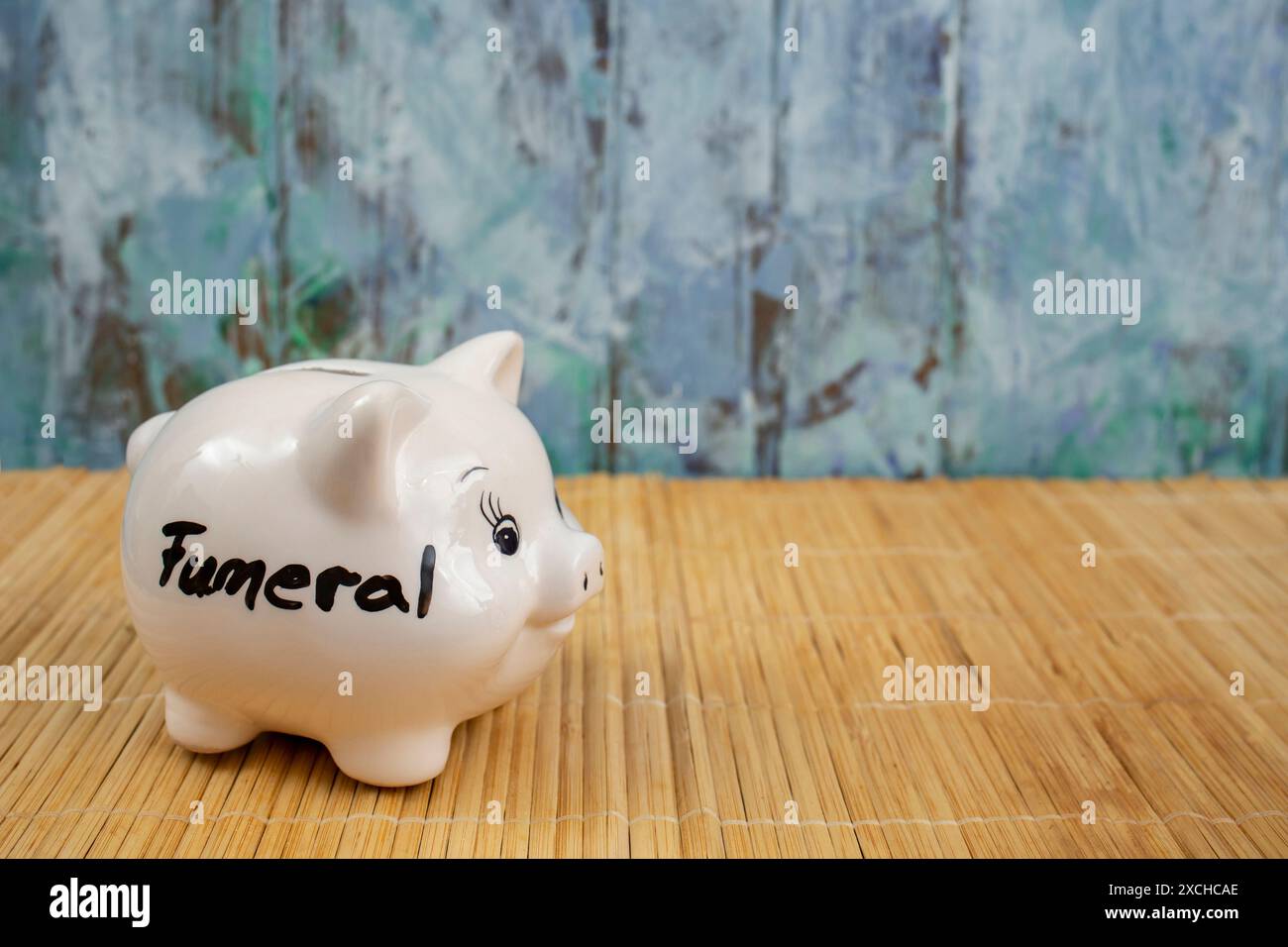 Begräbniswort geschrieben auf einer weißen Keramik-Schweinebank, Nahaufnahme Stockfoto