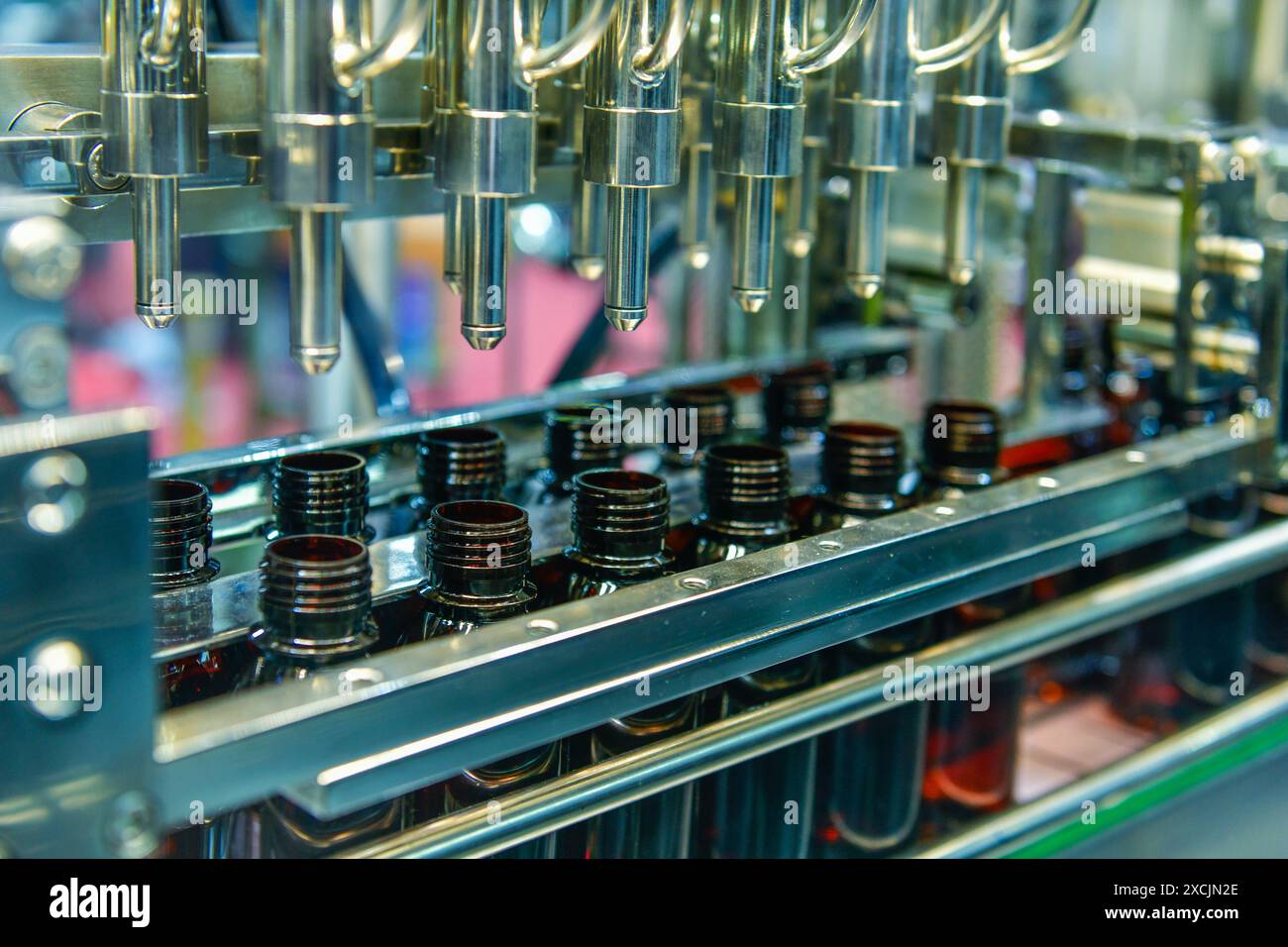 Glasflaschen in einem Förderband auf einer hochwertigen automatischen vertikalen Abfüllmaschine. In der Produktionslinie des Werks Stockfoto