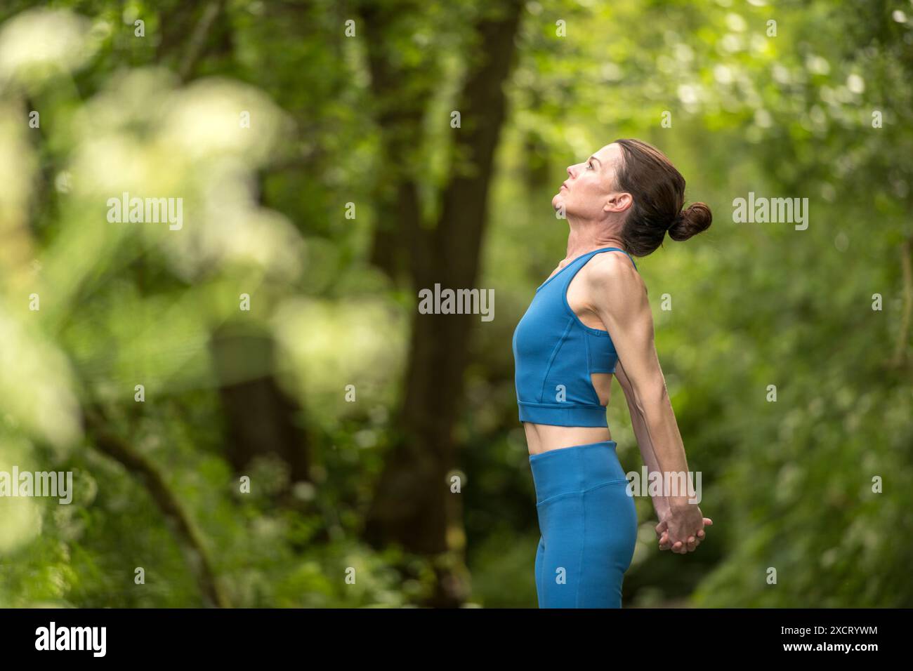 Sportliche Frau, die im Park Arm dehnt, warm-up-Routine. Stockfoto