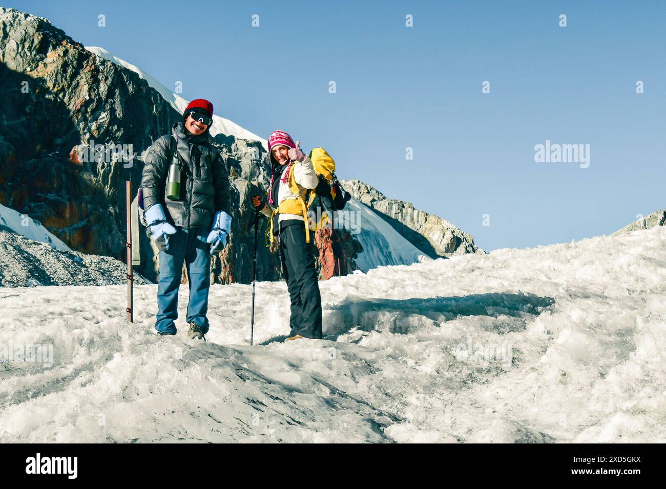Zwei Trekker stehen auf dem Gletscher mit Blick auf die Kamera. Chola Gletscherpass im Himalaya. Ein männlicher nepalesischer Reiseleiter, führender Touristenkunde in Sagarmatha nat Stockfoto