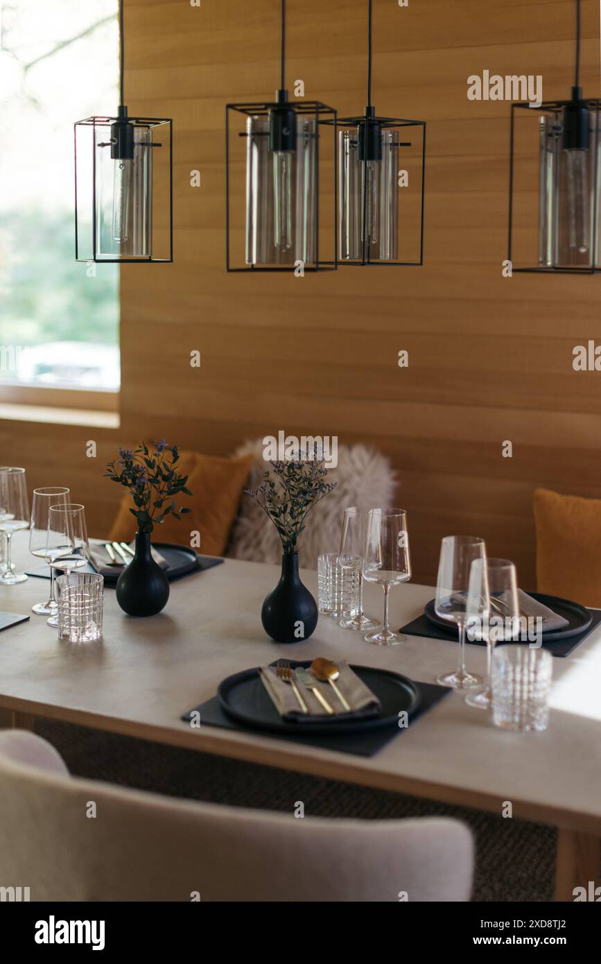 Moderner Essbereich mit stilvoller Tischeinrichtung und minimalistischer Einrichtung Stockfoto