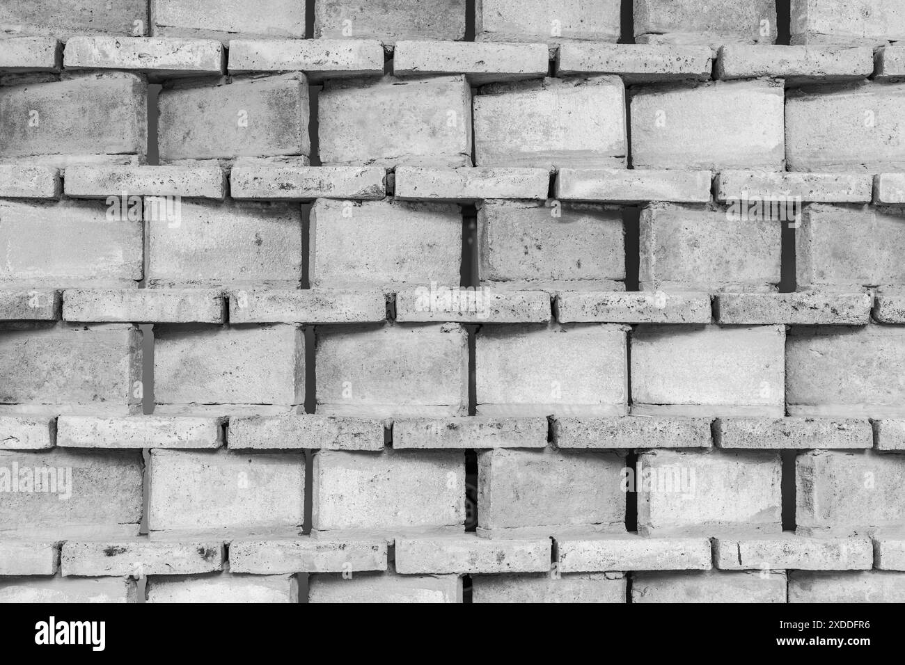 Hintergrund der Betonmauerwand. Grauer Zementfliesenblockhintergrund, Textur der Ziegeloberfläche. Stockfoto