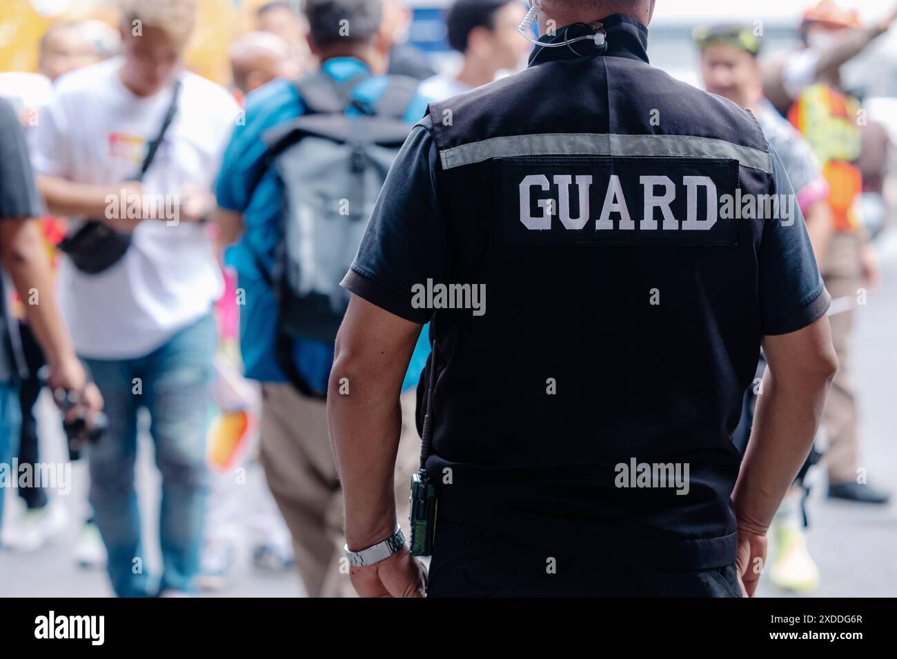 Wachmann aus der Nähe in öffentlichen Bereichen, der sichere Personen steht oder draußen steht. Stockfoto