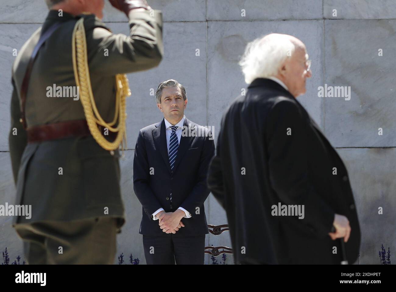 Taoiseach Simon Harris (Mitte) beobachtet, wie der irische Präsident Michael D Higgins während einer Stardust-Zeremonie im Garden of Remembrance in Dublin einen Kranz legt, um die Opfer, Überlebenden und die Betroffenen des Stardust-Feuers in Dublin zu ehren. Bilddatum: Sonntag, 23. Juni 2024. Stockfoto