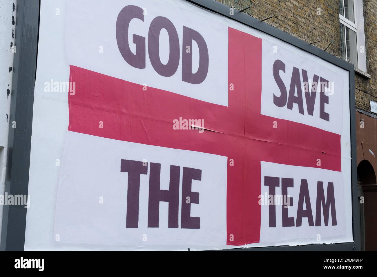 London, UK, 23. Juni 2024. Eine Plakatwand mit der Flagge von St. George und den Worten „God Save the Team“ des Künstlers Corbin Shaw erscheint an verschiedenen Orten, um zu hinterfragen, was England heute repräsentiert. Quelle: Eleventh Photography/Alamy Live News Stockfoto