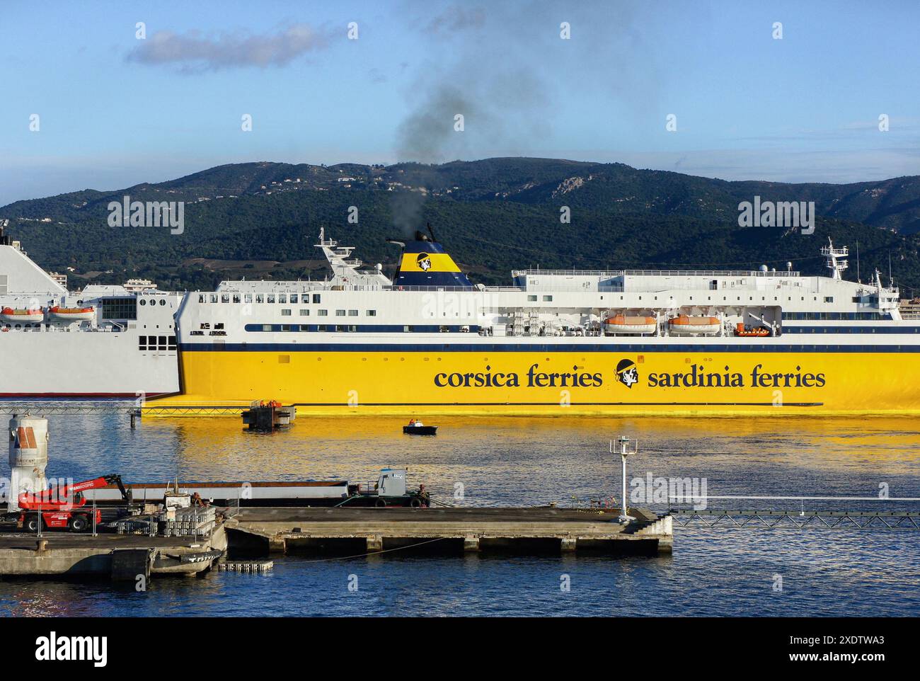 Ajaccio, Korsika, Frankreich. 23. Juni 2024: Corsica Ferries fährt im Hafen mit dem Logo des Unternehmens auf dem gelben Rumpf und dem Trichter. Der Staatsrat, die oberste Verwaltungsgerichtsbarkeit, hat ein Urteil erlassen, in dem die Rechtsnatur von Seefahrtslotsdiensten als "Gebühr für erbrachte Dienstleistungen" endgültig ausgeschlossen wurde, nachdem Corsica Ferries einen Erlass über die Kosten einer Pilotenstation auf Korsika für nichtig erklärt hatte. In vielen Häfen weltweit war die Entschädigung für Piloten immer umstritten. Quelle: Kevin Izorce/Alamy Live News Stockfoto