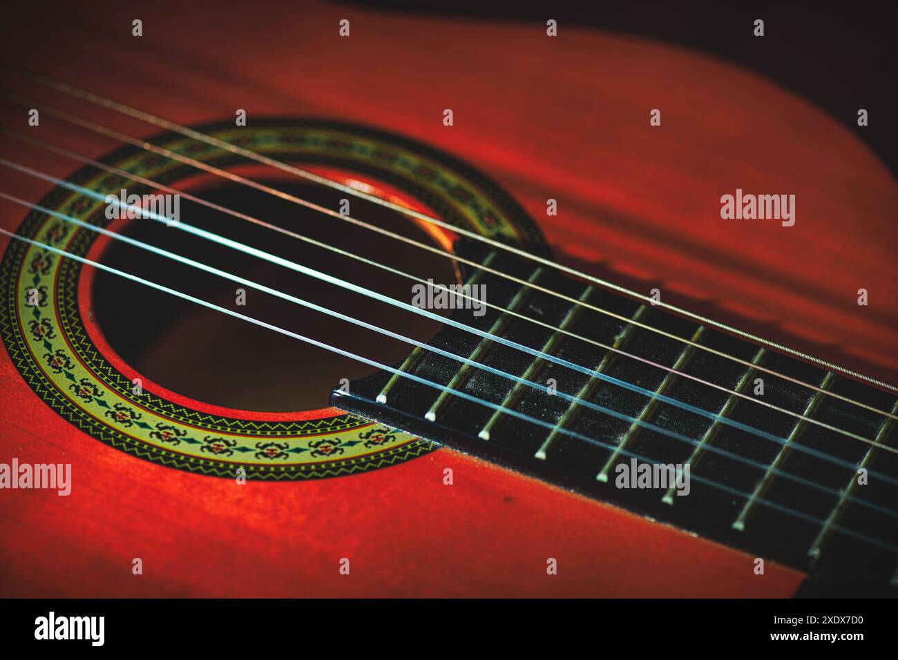 Details von Nylonsaiten einer klassischen Gitarre auf neutralem Hintergrund Stockfoto