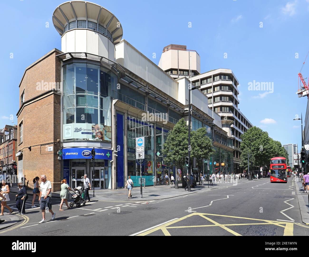 Blick auf die Tottenham Court Road, London, Großbritannien. Zeigt Geschäfte und Büros auf der Westseite, einschließlich Boots Store, Fußgänger und neuer Routemaster Bus. Stockfoto