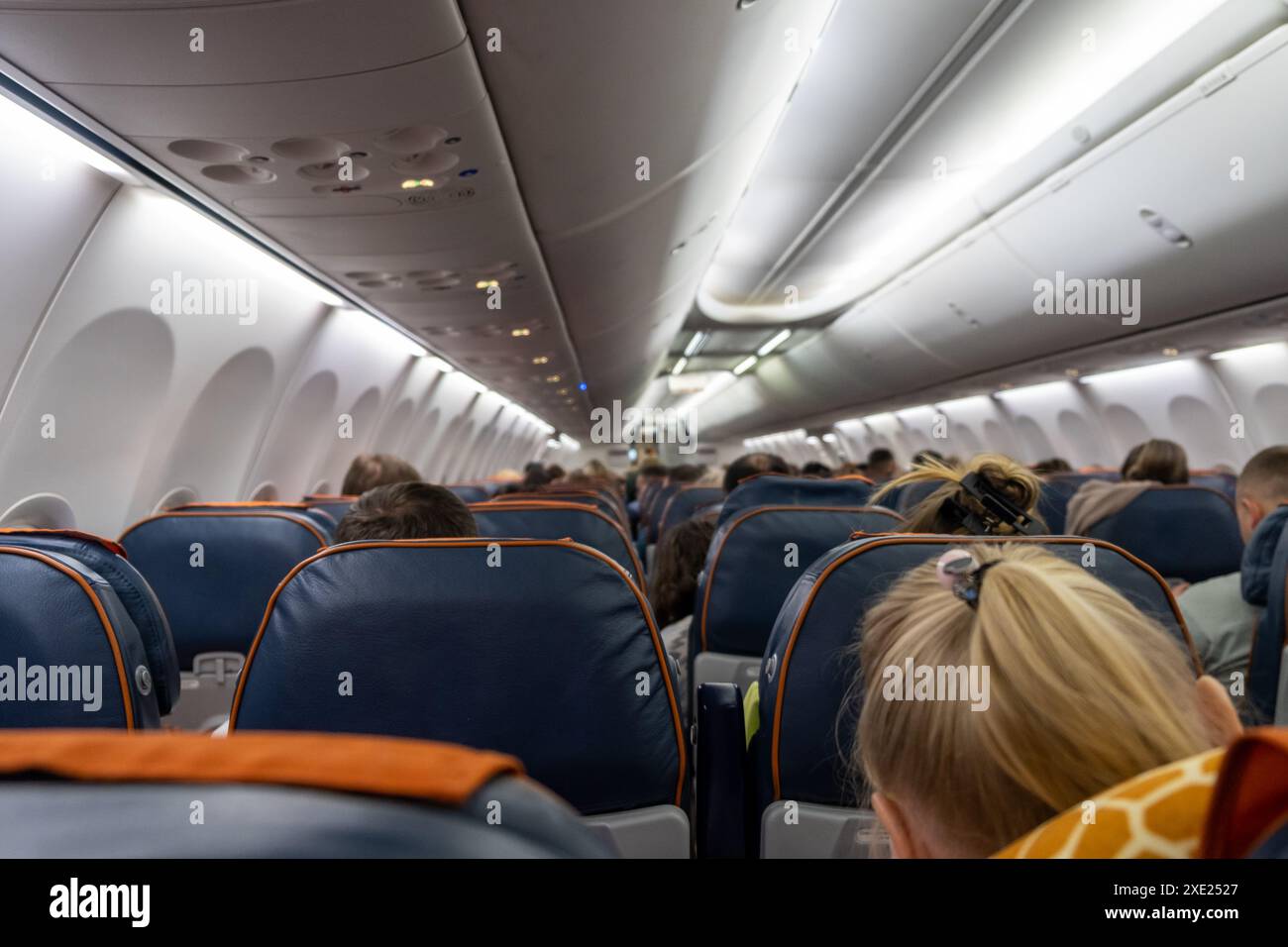 Wunderschöne Flugbegleiter erklären den Passagieren, wie man sie benutzt Stockfoto