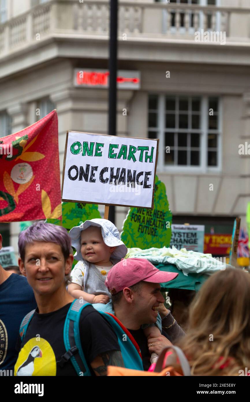 Plakat „One Earth, One Chance“, mit Baby, im Restore Nature Now march, London, UK, 22. Juni 2024 Stockfoto