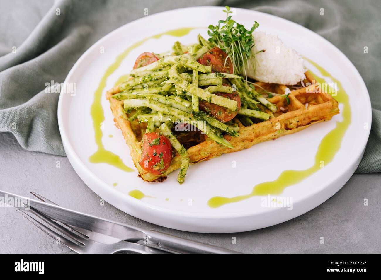 Nahaufnahme mit leckeren veganen Kartoffelwaffeln mit Pesto und frischem Naturgemüse Stockfoto