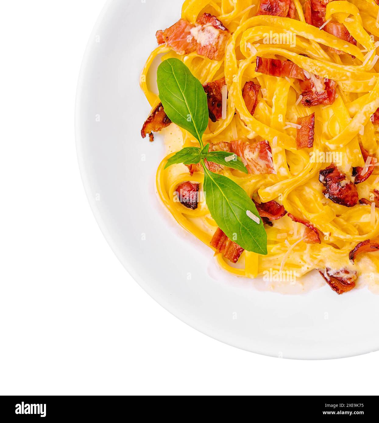 Pasta mit Speck und Basilikum auf weißer Platte Stockfoto