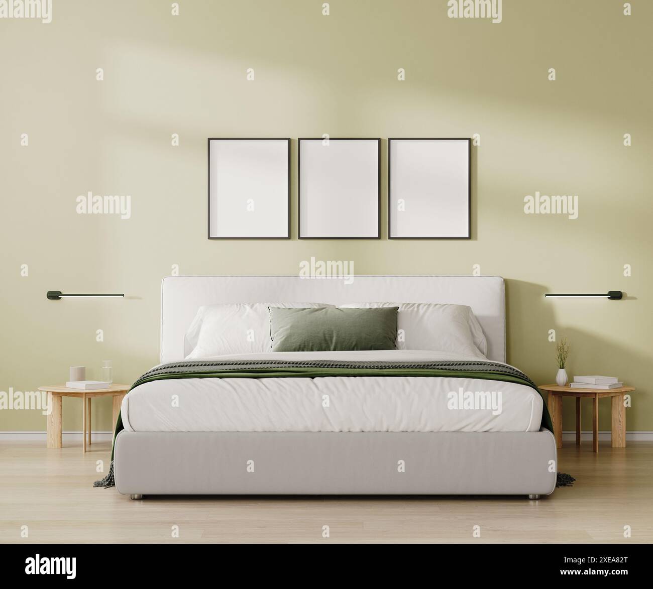 Drei leere Rahmen über dem Bett im Schlafzimmer in hellgrünem Ton, 3D-Rendering Stockfoto