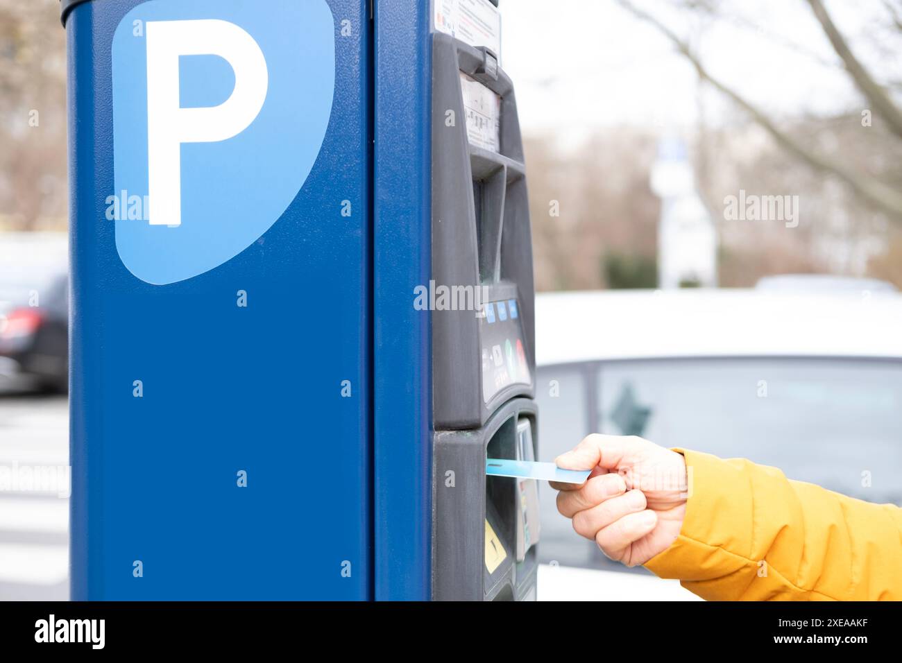 Fahrer bezahlt für Parken über ein elektronisches Straßenterminal, bequeme Parklösungen, kontaktloses und effizientes Parken Stockfoto