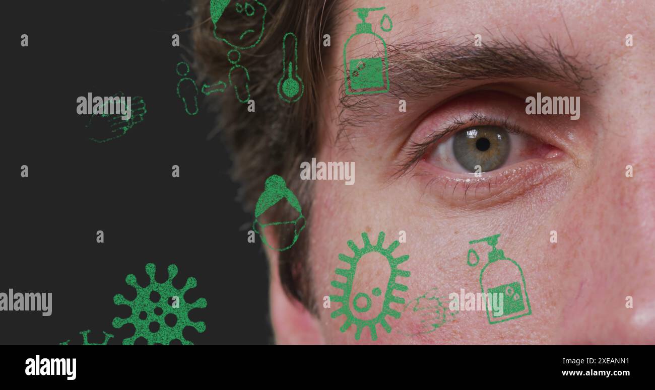 Mehrere Virus-Konzept-Icons, die sich gegen Nahaufnahme eines kaukasischen Mannes Auge schweben Stockfoto