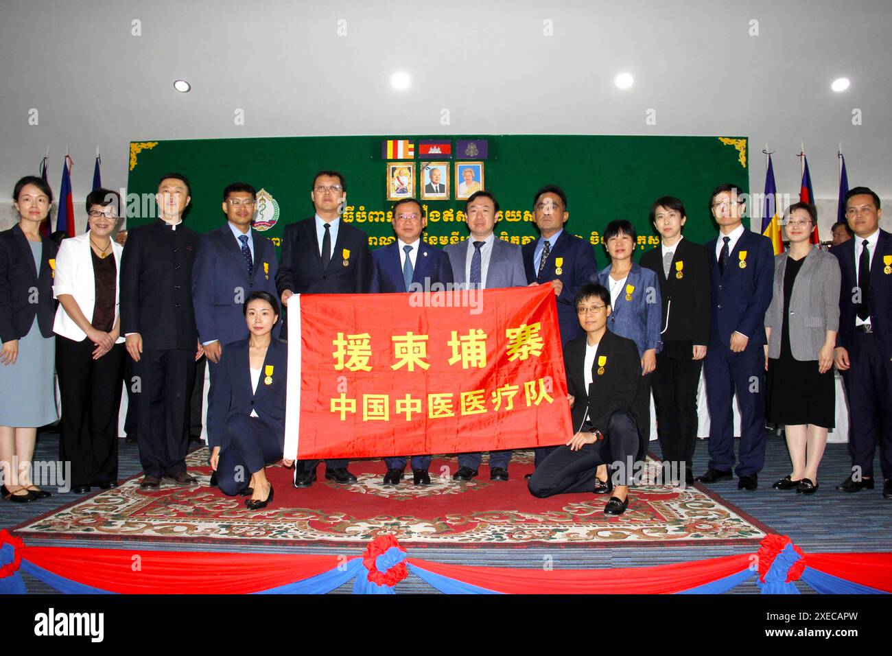 (240627) -- PHNOM PENH, 27. Juni 2024 (Xinhua) -- Kambodschas Gesundheitsminister Chheang Ra (6. L, zurück) posiert für ein Gruppenfoto mit Mitgliedern des medizinischen Hilfsteams der traditionellen chinesischen Medizin (TCM) in Phnom Penh, Kambodscha, 27. Juni 2024. Kambodscha verlieh am Donnerstag die ehrenvolle Medaille der Regierung an das zweite Team der medizinischen Hilfe für die traditionelle chinesische Medizin (TCM), nachdem sie ihre einjährige Mission zur Unterstützung des Landes bei der Bekämpfung der COVID-19 und anderer Krankheiten erfolgreich abgeschlossen hatten. MIT „Kambodscha vergibt ehrliche Medaillen an Experten der traditionellen chinesischen Medizin“ Stockfoto