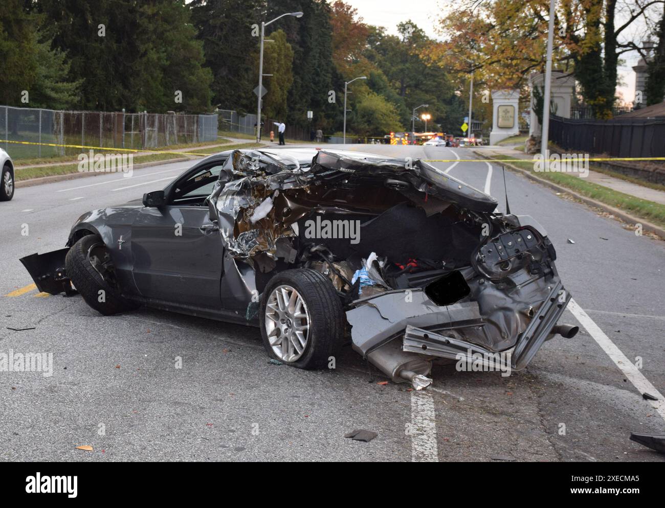 Foto des Ford Mustang in der letzten Pause, das Heckaufprallschäden des Schulbusses zeigt, mit der Unfallszene der Busse in der letzten Pause im Hintergrund. Quelle: Baltimore Police Department. Baltimore, MD-School Bus Kollision mit einem Transitbus, 1. November 2016 Stockfoto