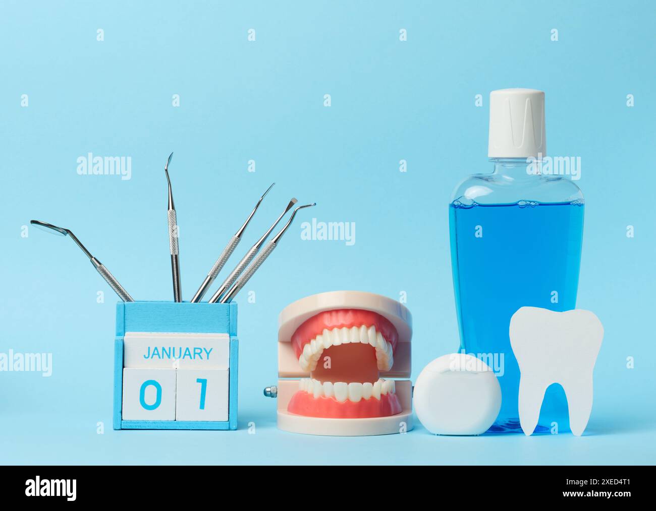 Plastikflasche mit Mundwasser, Zahnarztmedizinische Instrumente auf blauem Hintergrund Stockfoto