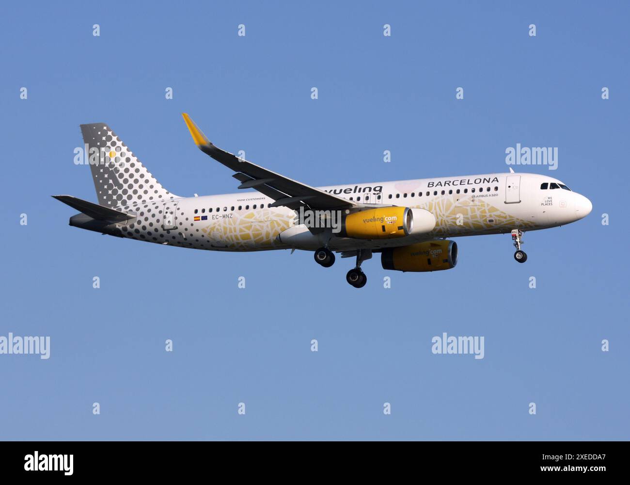 Ein Airbus A320 von Vueling mit einem speziellen Werbeziel Barcelona nähert sich Gatwick Stockfoto