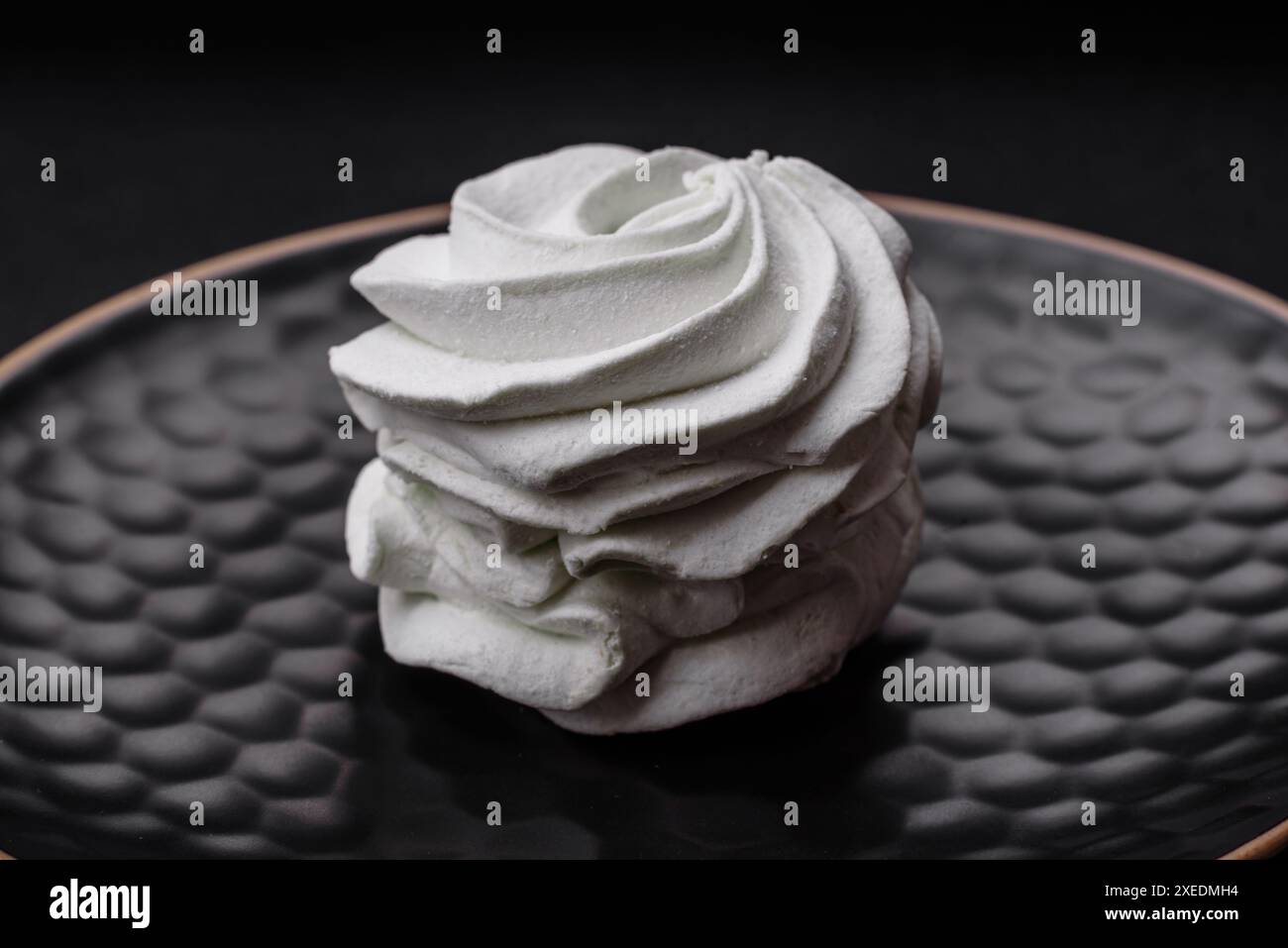 Köstlicher süßer Marshmallow auf dunklem Betonhintergrund Stockfoto