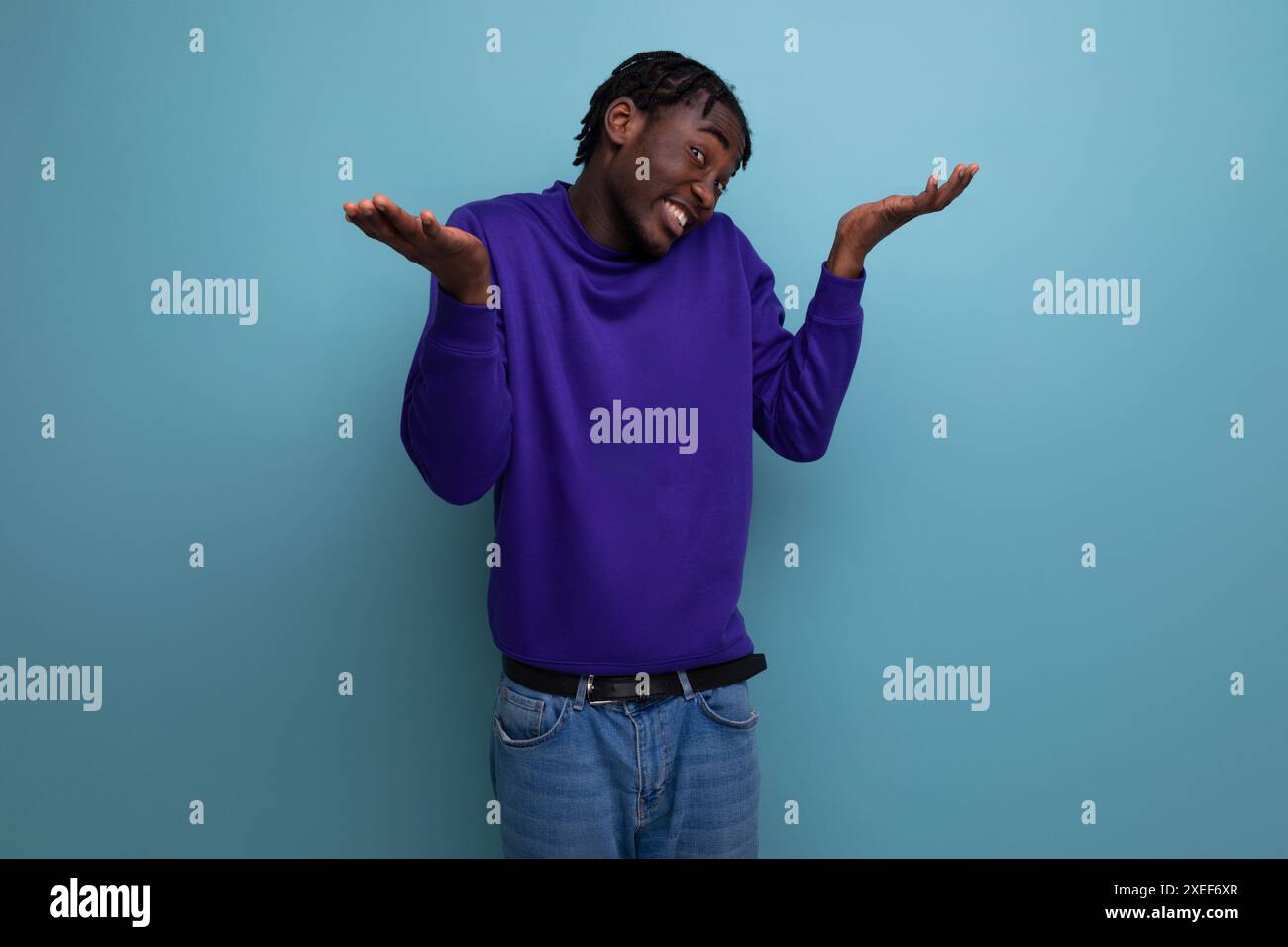 Porträt eines frustrierten afroamerikanischen jungen Erwachsenen in Jeans, isoliert auf schlichtem Hintergrund Stockfoto