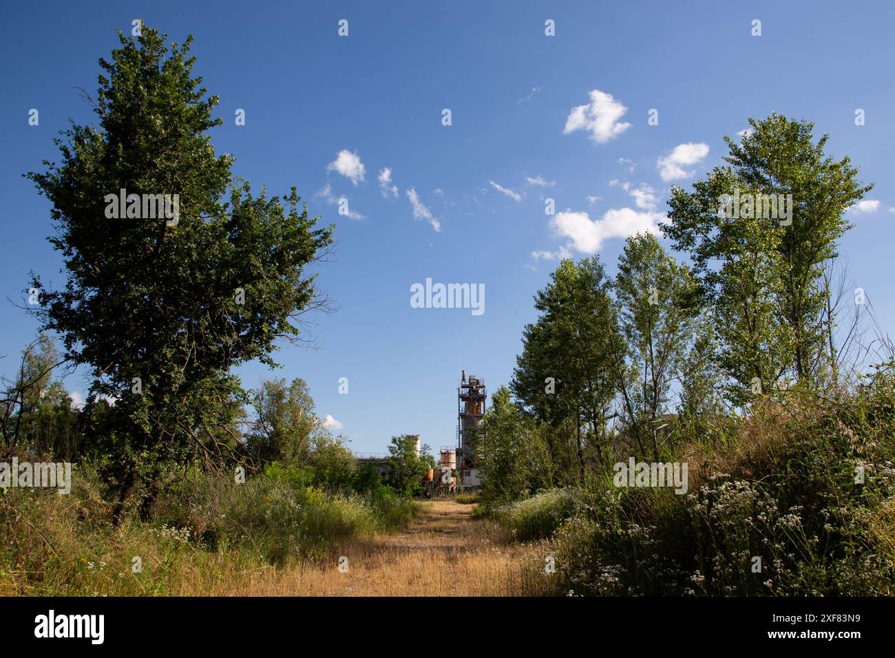 Verlassene Industriestandorte mit verlassenen Gebäuden und wilder Vegetation Stockfoto