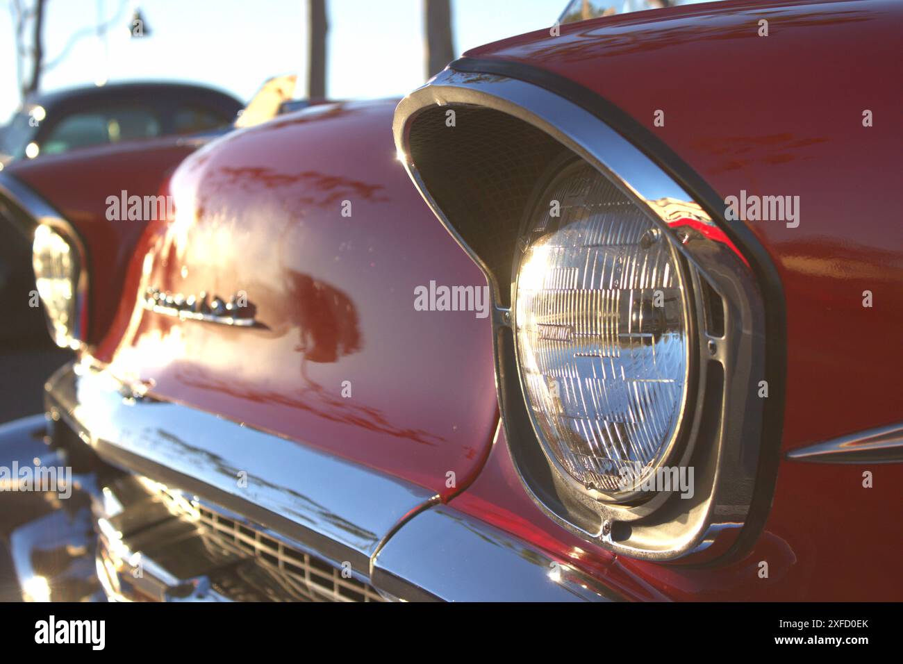 Ein abgewinkelter Blick auf eine 1957 Chevy Bel Air Front, hervorgehoben durch den frühen Sonnenaufgang am Morgen. Stockfoto