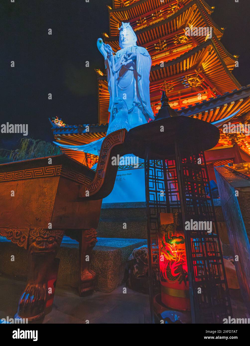 Jakarta, Indonesien - 11. Mai 2024. Ein Foto einer hell erleuchteten Statue der Guanyin-Göttin, die in warmes Licht getaucht ist und vor einem traditionellen Pago steht Stockfoto