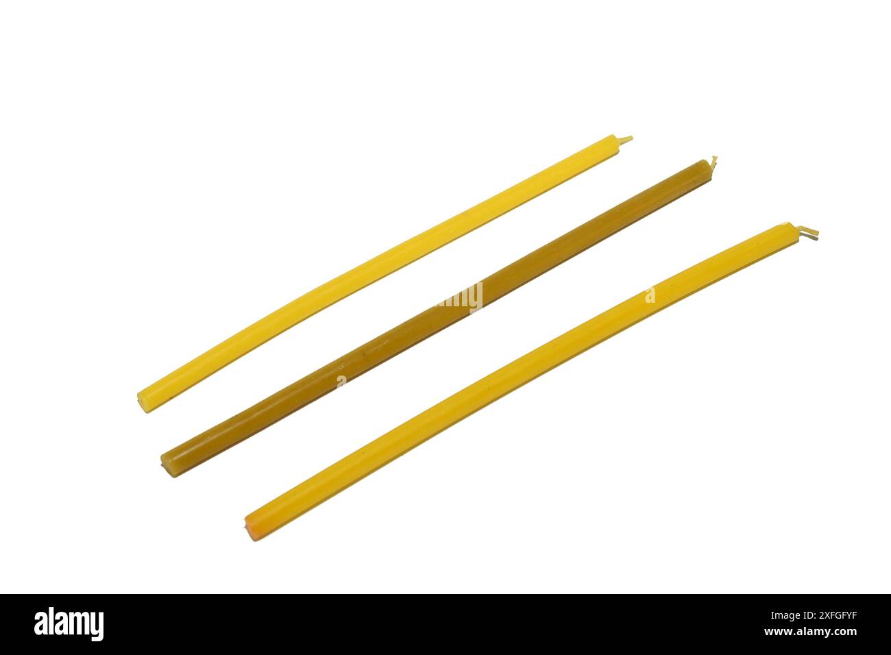 Drei Wachskerzen, die in der Kirche verwendet werden, liegen auf weißem Hintergrund. Stockfoto