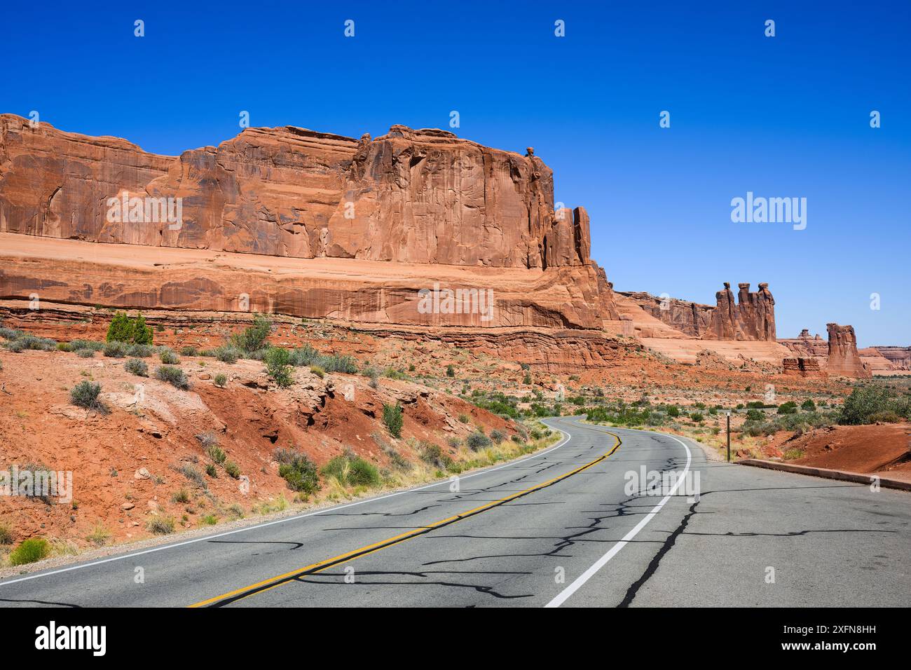 Die Straße im Arches National Park schlängelt sich vorbei an Sandsteinformationen ohne Autos Stockfoto