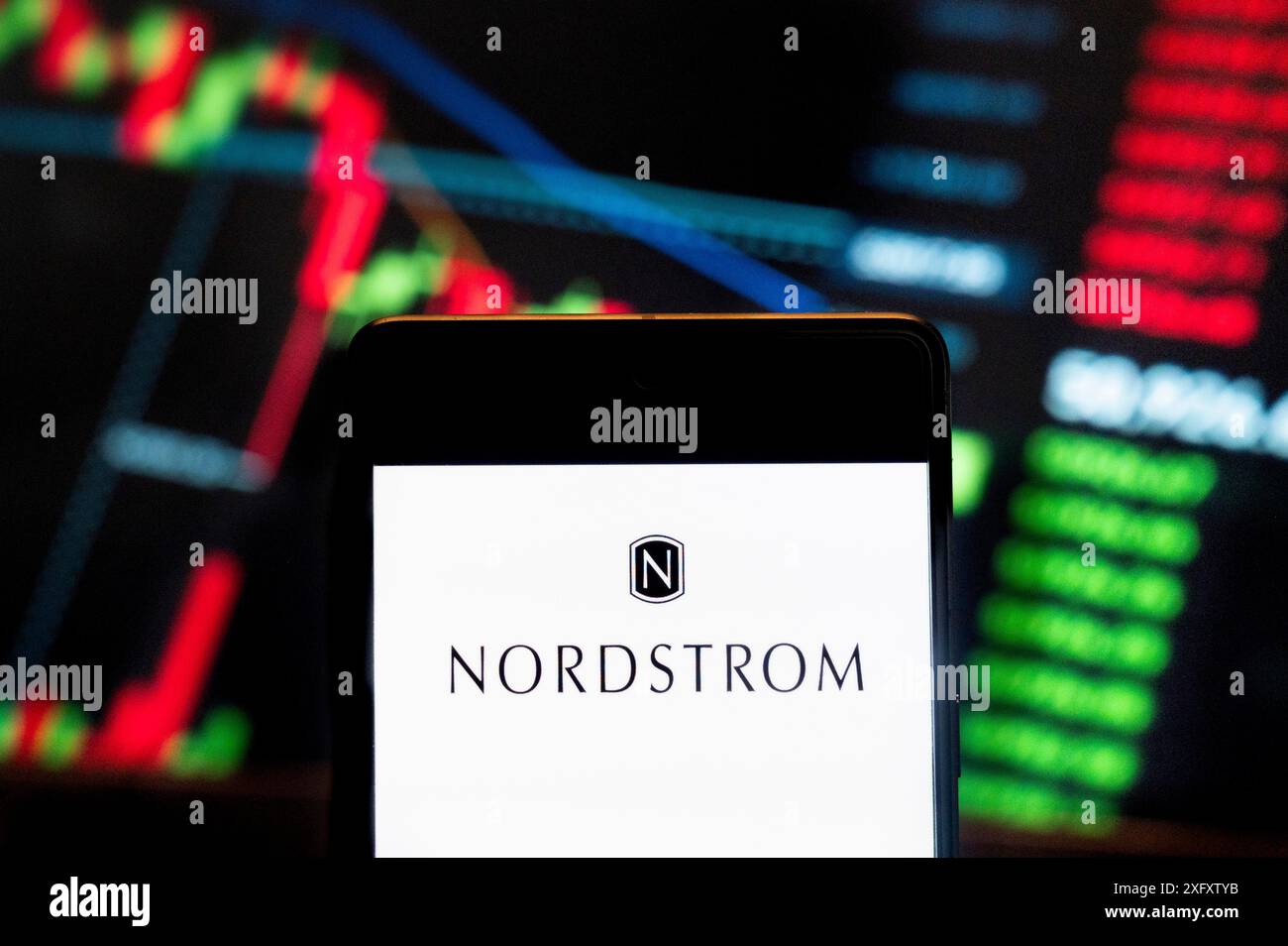 In dieser Fotoabbildung wird das Logo der amerikanischen Kette von Luxusschmuck-Kaufhäusern Nordstrom (NYSE: JWN) auf einem Smartphone mit einem wirtschaftlichen Börsenindex im Hintergrund angezeigt. Stockfoto