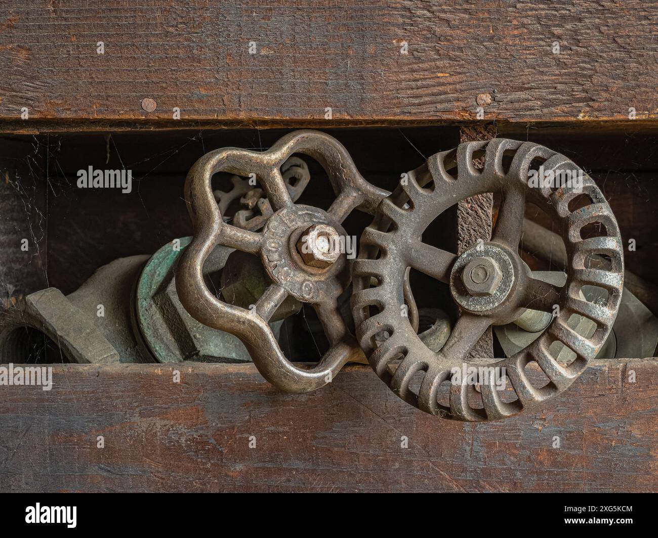 Alte Wasserhähne in einem alten Holzständer. Stockfoto