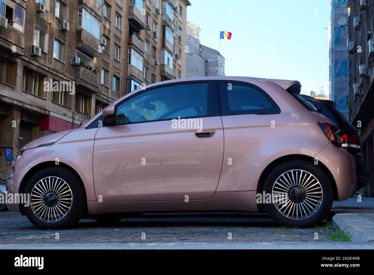 Bukarest, Rumänien - 16. Juni 2024: Seitenansicht des neuen Fiat 500 pinkfarbenen Autos in der Nähe des Appartementhauses Stockfoto Bukarest, Rumänien - 16. Juni 2024: Seitenansicht des neuen Fiat 500 pinkfarbenen Autos in der Nähe des Appartementhauses Stockfoto